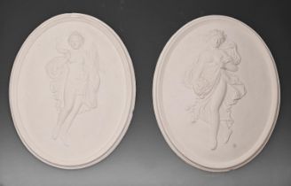 A pair of oval plaster bas reliefs of maidens emblemeatic of Summer and Autumn, 43cm