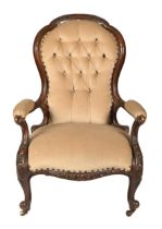 A Victorian walnut open armchair, the frame carved with cabochons, pottery castors Condition of