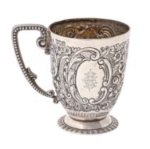 An Edwardian silver christening mug, chased with putto and flowers, beaded handle, 95mm h, maker's