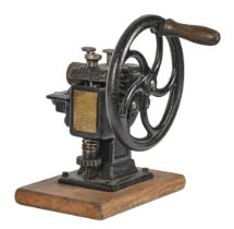 A cast iron hand cranked leather skiving machine, c1900, mounted on wooden base, 33cm h Chip to stem