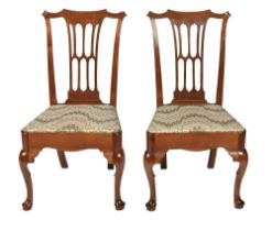 A pair of George III walnut and fruitwood dining chairs, on cabriole forelegs with pad feet Good,