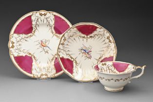 A Rockingham breakfast cup, saucer and teapot stand, c1830-1842, of three spur handle shape, painted