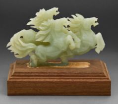 A Chinese jade group of three horses, 20th c, wood base, 19cm h Undamaged