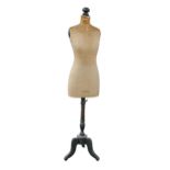 A Stockman cloth covered and ebonised tailor's mannequin, early 20th c, on tripod, 158cm h In well