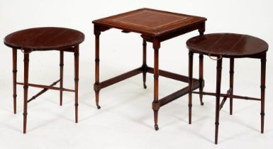 A mahogany nest of tables in faux bamboo Regency style, with inset tooled leather top, on brass