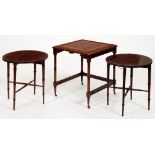 A mahogany nest of tables in faux bamboo Regency style, with inset tooled leather top, on brass