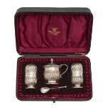 A Victorian silver wrythen fluted condiment set, pepperette 62mm h, by Horace Woodward & Co,