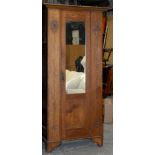 An Edwardian Art Nouveau oak wardrobe