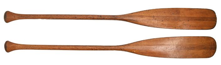 A pair of wooden paddles, early 20th c, 121cm l Good condition