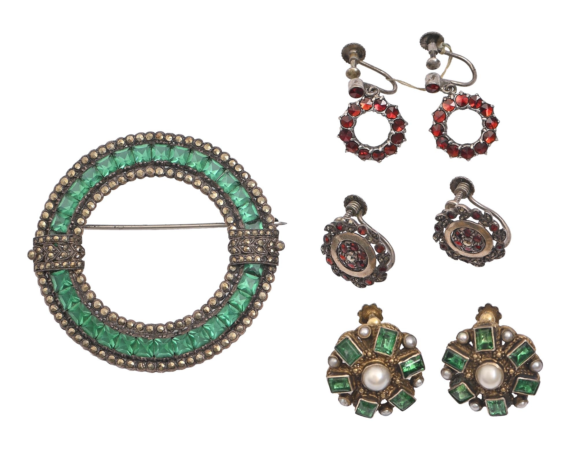 A silver, green paste and marcasite circular brooch, c1925, 50mm diam and three pairs of