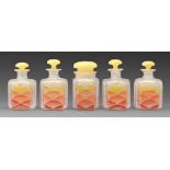 A set of five Art Deco enamelled glass salt cellars and bottles and stoppers, c1930, 11cm h and