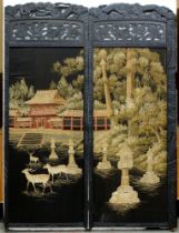 A South East Asian ebonised two leaf screen, with needlework landscape panel, the frame carved