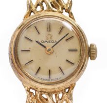 An Omega 9ct gold lady's wristwatch, 17mm diam, on 9ct gold bracelet of cast openwork links, 18.