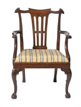 A Victorian mahogany elbow chair,  with pierced splat and carved front legs  with claw and ball