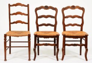 A pair of early 20th c ash ladder back rush seated dining chairs and another, later NO obvious