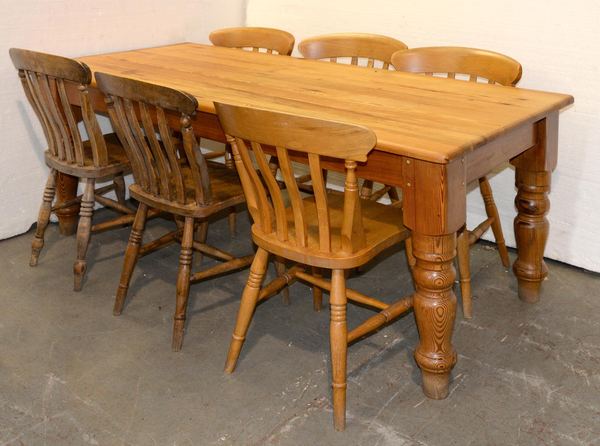 A waxed pine kitchen table and six kitchen chairs