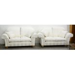 A pair of modern chesterfield sofas, in white stripe upholstery, on light wood bun feet with brass