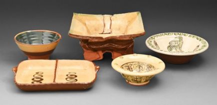 Studio pottery. A divided dish and four bowls, slipware or glazed and painted earthenware, various