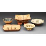 Studio pottery. A divided dish and four bowls, slipware or glazed and painted earthenware, various