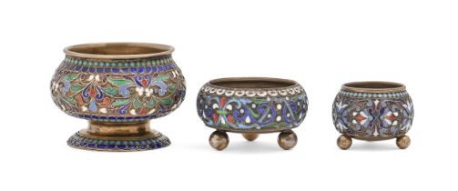 Three Russian silver gilt and cloisonne enamel salt cellars, 63mm diam and smaller, all Moscow, by