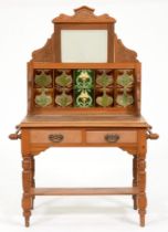 An early 20th c waxed pine washstand,  the tiled back with bevelled mirror, on turned legs and