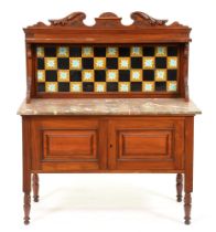 A Victorian carved mahogany marble topped wash stand, with tiled splash back, the lower part