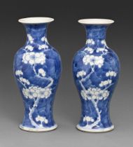 A pair of Chinese blue and white vases, 19th / 20th c, painted with prunus on a cracked ice