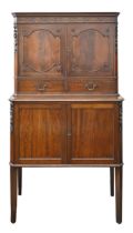 A 1930s mahogany cocktail cabinet, with carved decoration, enclosed by panelled doors, on square