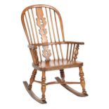 A Victorian yew and elm Windsor rocking chair,  with pierced splat and spindle back, turned legs and