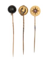 A Victorian stickpin, with gypsy set garnet and gold terminal, reverse engraved AS LONG AS WE BOTH