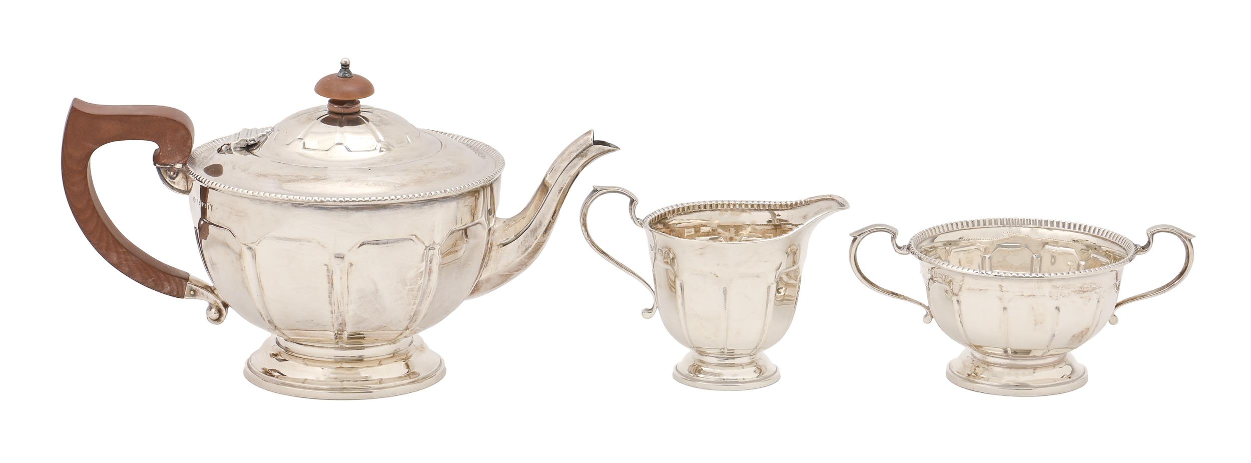 A George V silver tea service, of panelled design with beaded rim, teapot 14.5cm h, by Adie Brothers