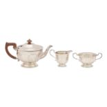 A George V silver tea service, of panelled design with beaded rim, teapot 14.5cm h, by Adie Brothers
