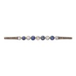 A sapphire and diamond brooch, early 20th c, millegrain and collet set in gold, 60mm l, 3.6g Good