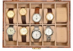 Eight Citizen, Seiko and other stainless steel or gold plated wristwatches, in faux walnut display