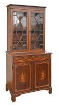 An Edwardian mahogany, satinwood and inlaid bookcase, the panelled doors to the lower part decorated