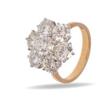 A diamond ring, of seven round brilliant cut diamonds, in 18ct gold, import marked London 1970, 5.