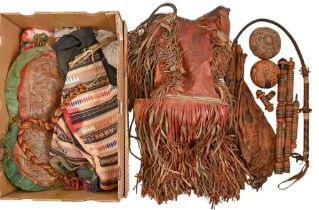 Ethnographica. A North African leather handled camel whip, a deeply fringed red leather water bag,