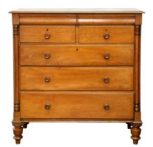 A Victorian oak chest of drawers, the four short and three long drawers flanked by a pair of