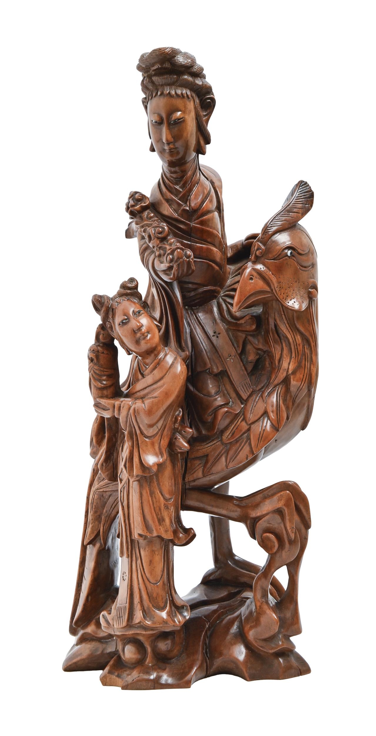 A Chinese rootwood carving of Guanyin on a phoenix with attendant, early 20th c, glass bead eyes,