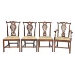 A set of four mahogany dining chairs,  including an elbow chair,  with carved and pierced splat,