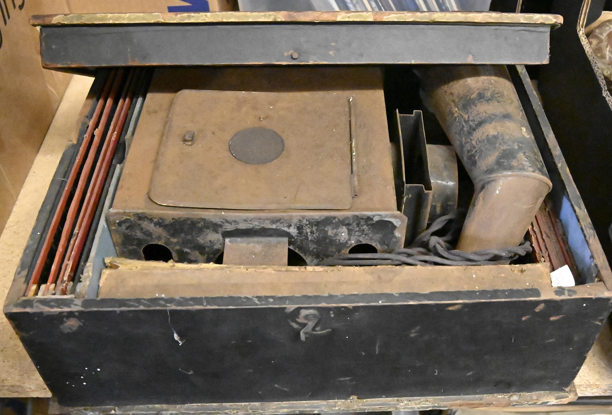 An Ernst Plank tinplate magic lantern, with lens, chimney and glass slides, in the original