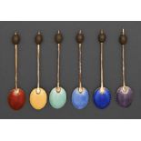 A set of six George V silver gilt and harlequin guilloche enamel coffee spoons, with bean