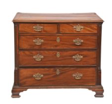 A George III mahogany chest of drawers,  of two short and three long drawers flanked by carved