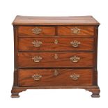 A George III mahogany chest of drawers,  of two short and three long drawers flanked by carved