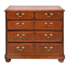 A walnut chest of drawers, cross grained mouldings, the top crossbanded, on bun feet, 86cm h; 98x