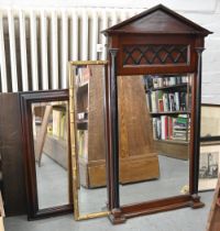 A Victorian style mahogany mirror of architectural design, the bevelled plate flanked by a pair of