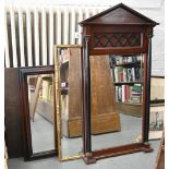 A Victorian style mahogany mirror of architectural design, the bevelled plate flanked by a pair of