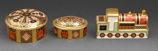 Two Royal Crown Derby Imari pattern boxes and covers and a locomotive paperweight, early 21st c,