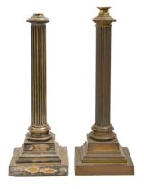 Two similar Edwardian brass or plated columnar oil lamps, the reeded shaft on stepped square foot,