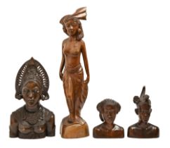 Three South East Asian carved hardwood head sculptures and a statuette of a semi-naked woman,